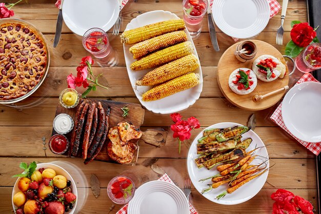 Grilled corn on a white plate on the dinner table