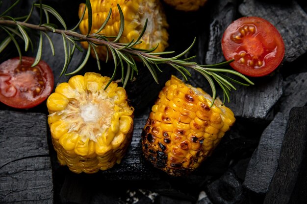 Grilled corn with rosemary and tomatoes