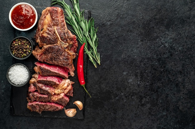 grilled cowboy beef steak on stone background with copy space for your text