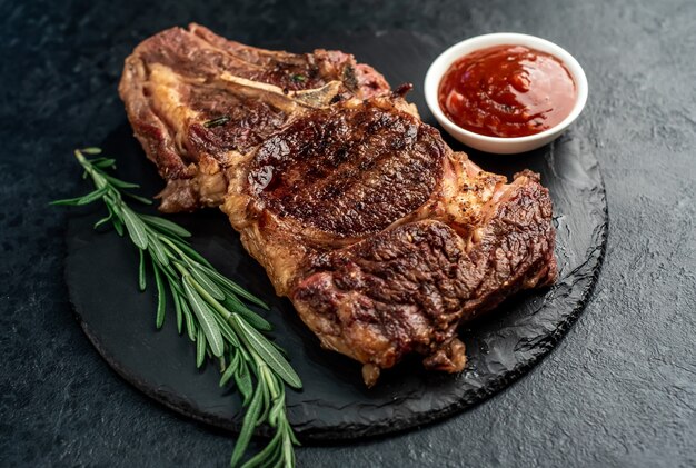 grilled cowboy beef steak on stone background