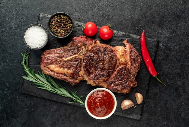 grilled cowboy beef steak on stone background