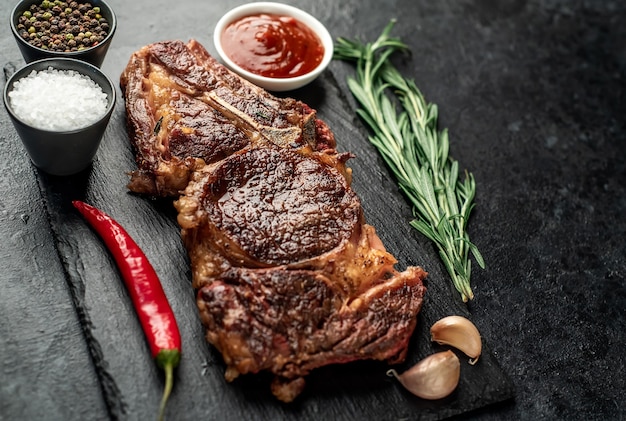 grilled cowboy beef steak on stone background