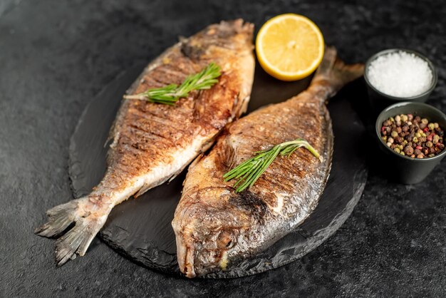 grilled dorado fish on stone background