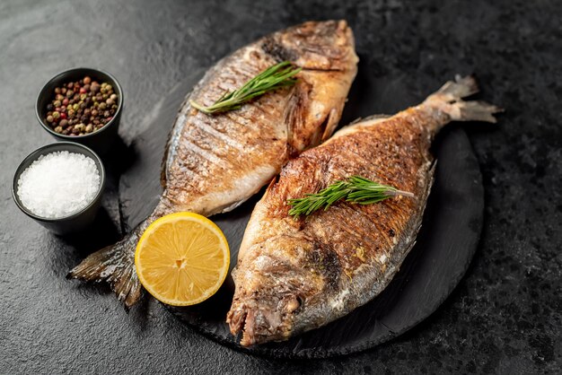 grilled dorado fish on stone background