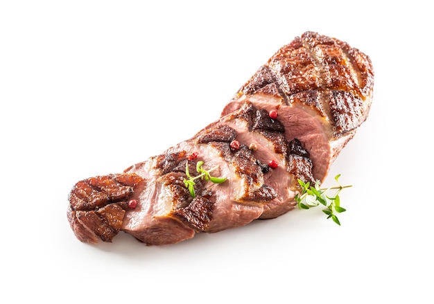 Grilled duck breast cut to slices on an isolated white background.