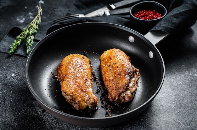 Grilled duck Breasts in a pan.