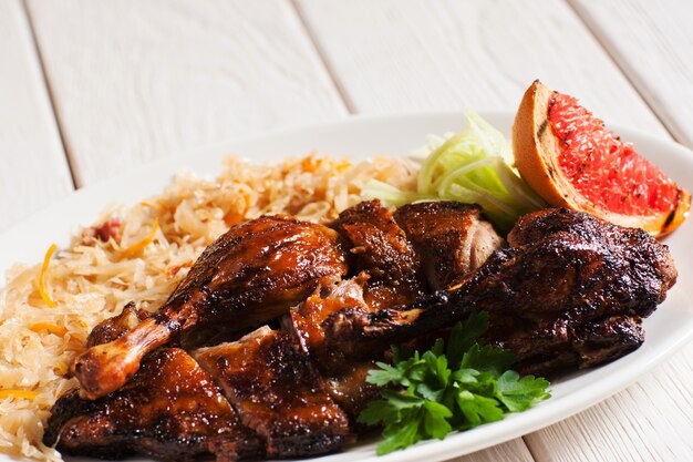 Grilled duck served with stewed cabbage and grapefruit slice