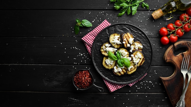 Grilled eggplant with feta cheese. Top view. Free space for your text.