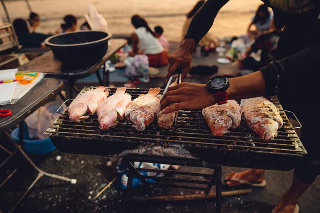 Premium Photo | Grilled fish by the sea street food