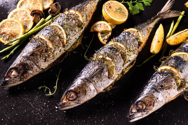 Grilled fishs and various vegetables on iron plate 