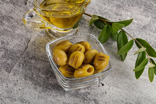 Grilled green olives appetizer snack in the bowl