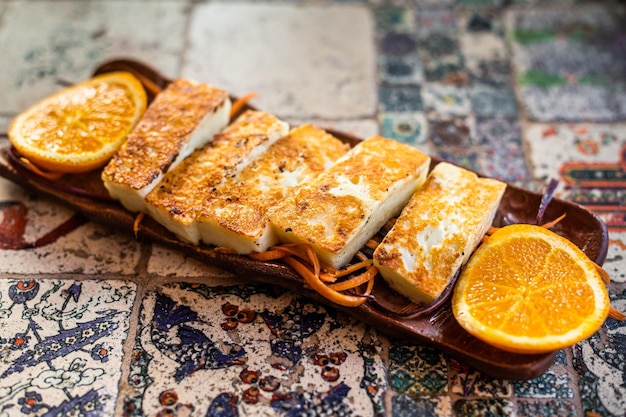 Grilled Halloumi Cheese on a plate with herbs Top view