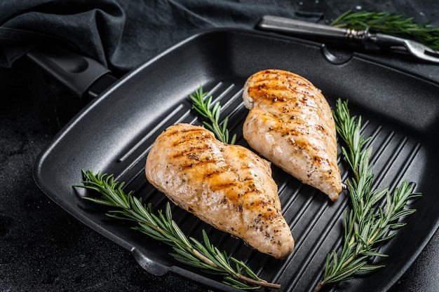 Grilled healthy chicken breasts cooked on a grill pan Black background Top view