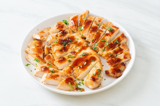 grilled honey chicken breast sliced on white plate