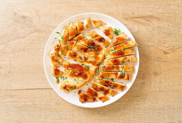 grilled honey chicken breast sliced on white plate