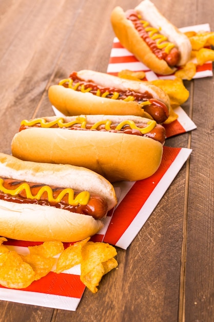 Grilled hot dogs on a white hot dog buns with mustard and ketchup.