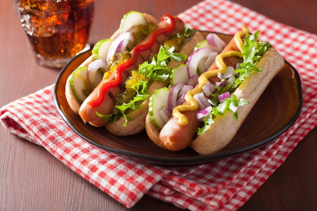 Grilled hot dogs with vegetables ketchup mustard