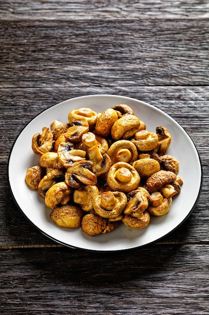 Grilled juicy mushrooms on a plate top view