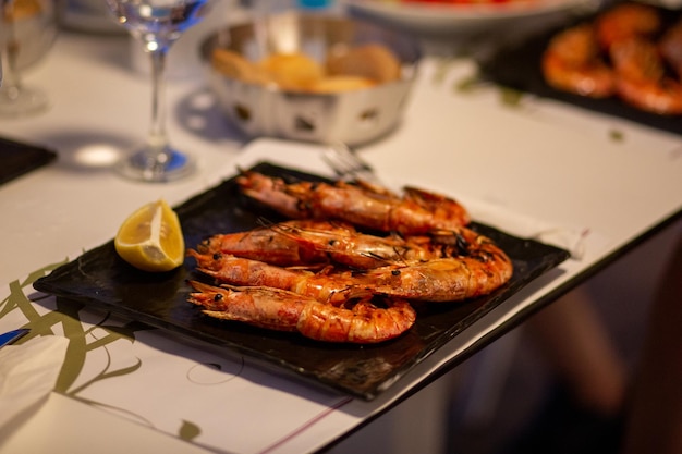 grilled king prawns with sauce in a restaurant