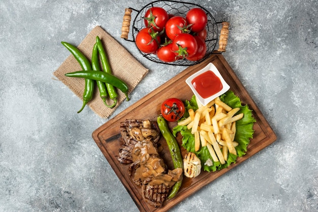 Grilled Lamb meat with french fries on wood plate