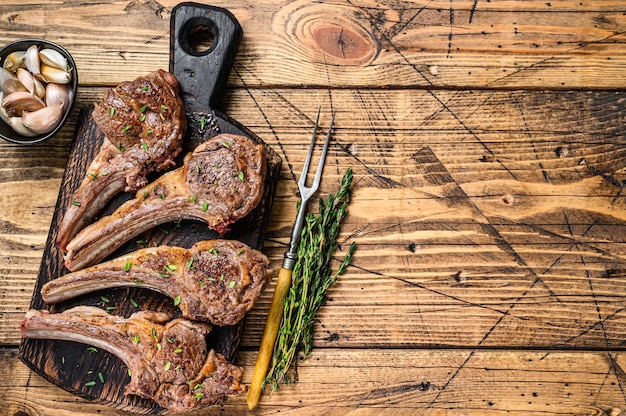 Grilled lamb mutton meat chops steaks on a cutting board