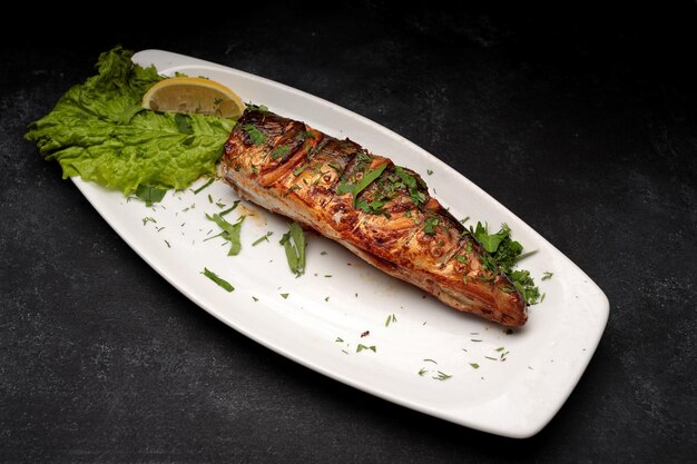 Grilled mackerel with herbs on a plate