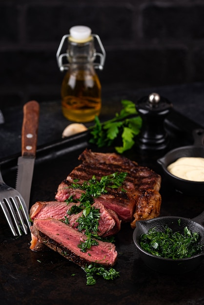 Grilled marbled rib eye steak with sauce