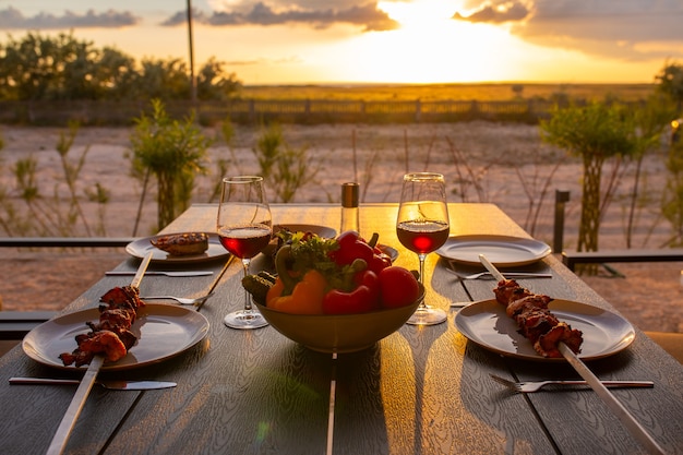 Grilled meat is served at homeGrilled meat with wine and vegetablesSummer on the terrace