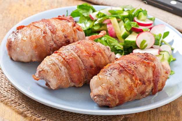 Grilled meat rolls wrapped in strips of bacon