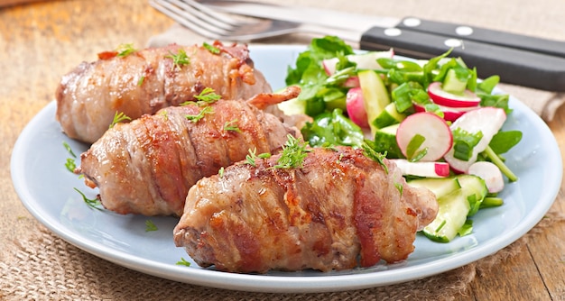 Grilled meat rolls wrapped in strips of bacon