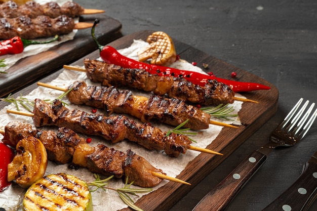 Grilled meat skewers barbecue served on board