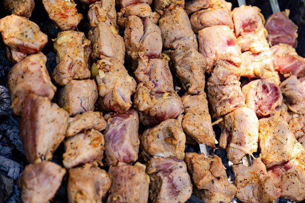 grilled meat skewers on charcoal grill closeup of grilled meat skewers with seasonings on a charcoal grill