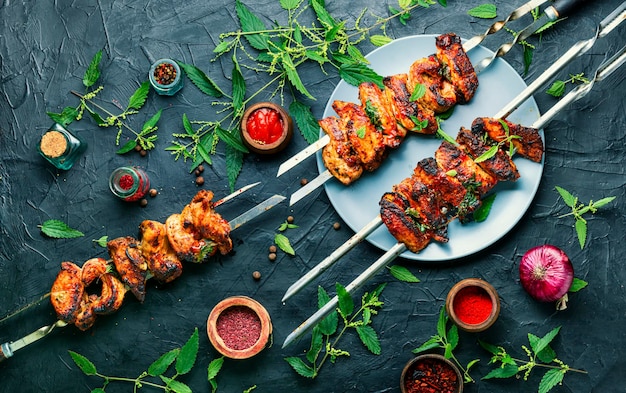 Grilled meat skewers or shish kebab pickled in nettle foliage