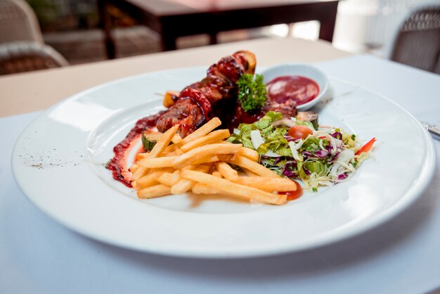 Grilled meat on the white plate. Restaurant.