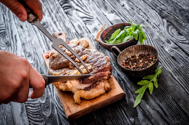 Grilled meat with garlic on a wooden board