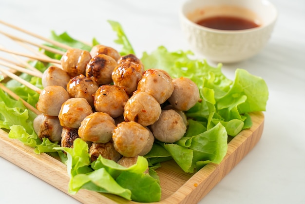 grilled meatballs skewer with spicy dipping sauce