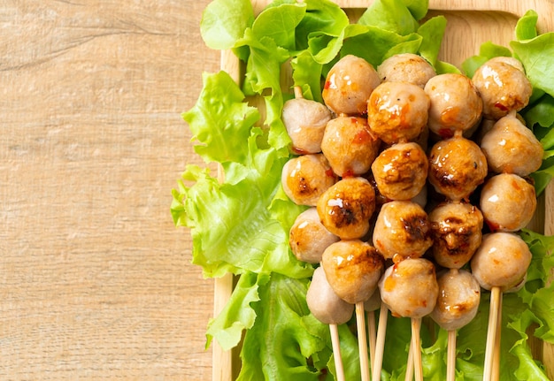 grilled meatballs skewer with spicy dipping sauce