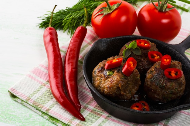 Grilled meatballs with chili pepper