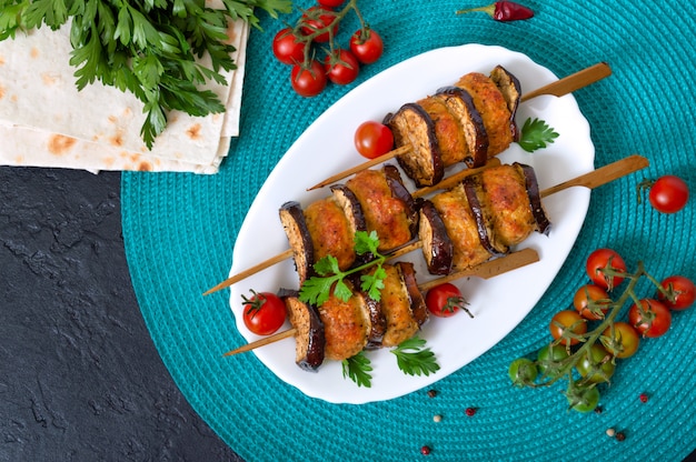 Grilled meatballs with eggplant on skewers