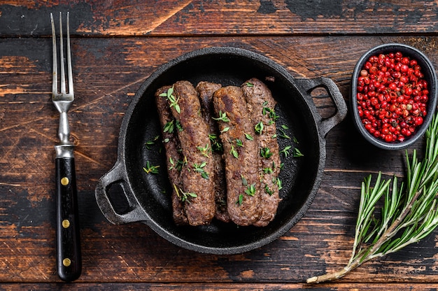 Grilled mince meat sausages in a pan.