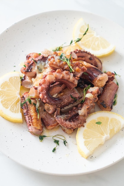 Grilled octopus or squid with butter lemon sauce and thyme