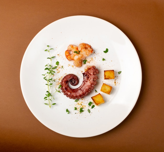 Grilled octopus on white plate