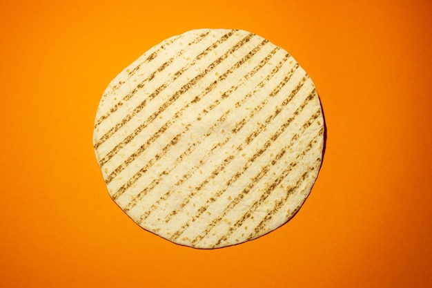 Grilled pita or tortilla on the orange background. mexican food
