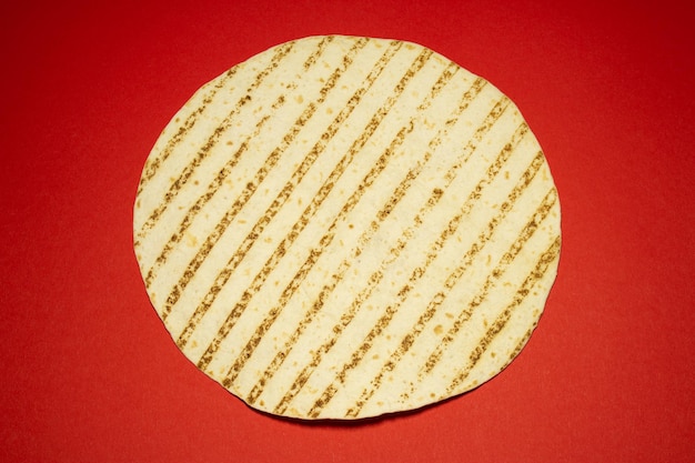 Grilled Pita or tortilla on the red background. Mexican food.