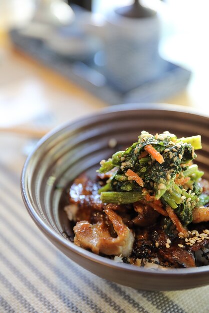 Grilled pork bowl japanese buta donburi on wood table