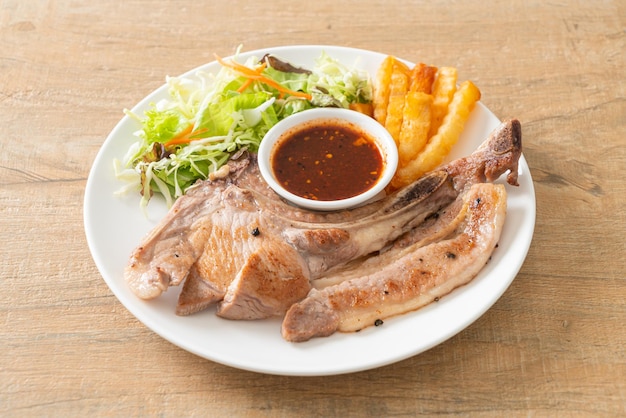 grilled pork chop steak with Thai spicy dipping sauce or Jaew sauce - fusion food style
