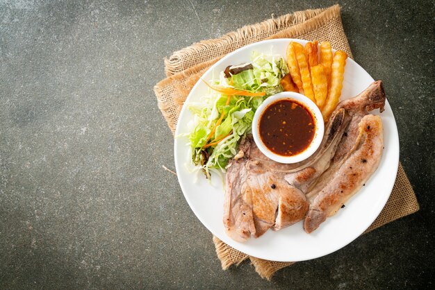 grilled pork chop steak with Thai spicy dipping sauce or Jaew sauce - fusion food style