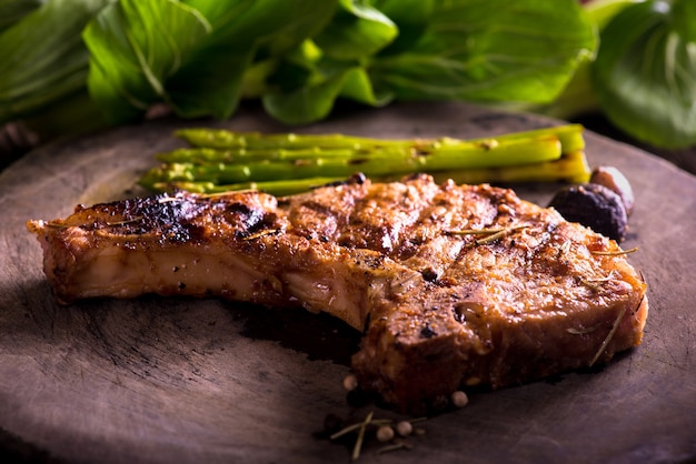 grilled pork chop with vegetable on wooden board