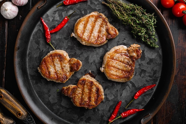 Grilled pork fillet meat set on old dark wooden table background top view flat lay