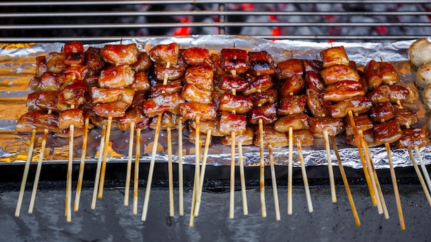 Photo grilled pork intestine in barbecue sticks on the grill